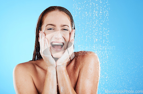 Image of Woman in shower, happy in portrait with hygiene and water drops, soap and clean with excited face on blue background. Facial, hydration and skincare with female cleaning body, foam and mockup space