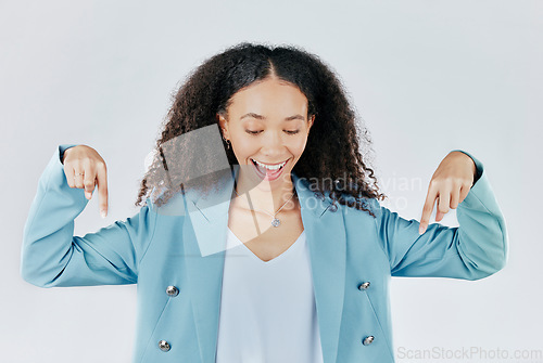 Image of Advertising, excited and woman pointing down at product placement, deal or sale isolated in studio white background. Happy, smile and cheerful businesswoman smiling for promotion announcement