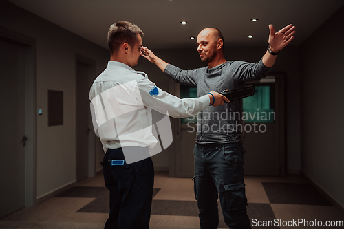 Image of Security guard making body searching procedure on man for finding hidden objects before entering in treasury department