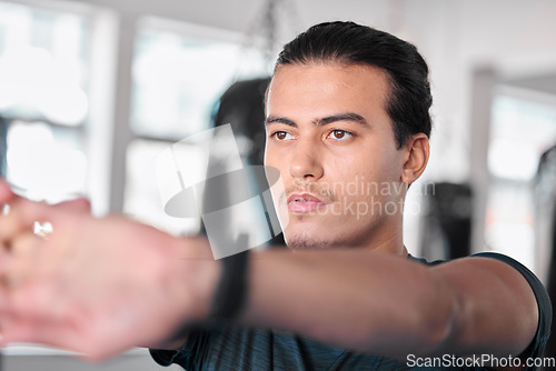 Image of Hands, stretching fingers and man in gym ready to start workout, training or exercise. Sports fitness, thinking and serious male athlete warm up, stretch or prepare for exercising for flexibility.