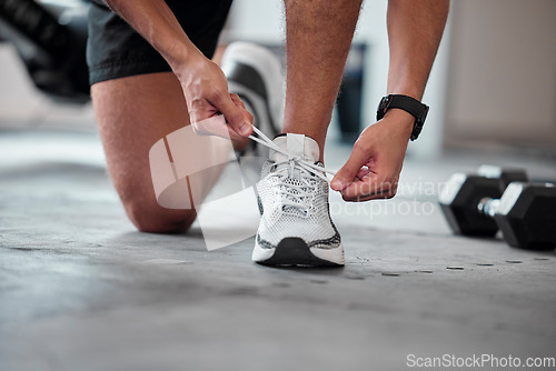 Image of Fitness, hands and tie shoes in gym to start workout, training or exercise. Sports, athlete and man tying footwear or sneakers to get ready or prepare for running, cardio or exercising for health.