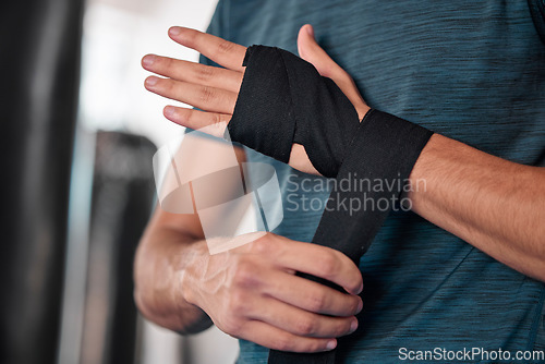 Image of Man wrapping hand, boxing and fitness with martial arts in gym, exercise and power with strong person. Workout, male boxer training in combat and sport, athlete ready to fight and closeup of hands