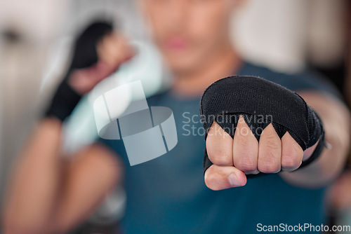 Image of Man, fist and boxing, fitness and martial arts in gym, exercise and power, strong person and punch. Workout, male boxer training in combat and sports, athlete ready to fight and mma fighter hand zoom