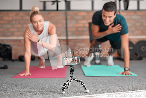 Image of Live streaming, phone fitness and people in exercise teamwork, workout and social media video on tripod. Happy athlete training, influencer couple of friends or sports content creation on smartphone