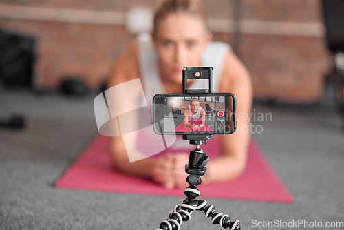 Image of Live streaming, fitness and phone of woman exercise, pilates or workout on social media or video platform on tripod. Gen z athlete, sports influencer or content creator training on smartphone screen