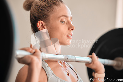 Image of Fitness, bodybuilding and a woman weightlifter in the gym for a workout to build a strong muscular physique. Exercise, weightlifting and a female bodybuilder training her body in a wellness center