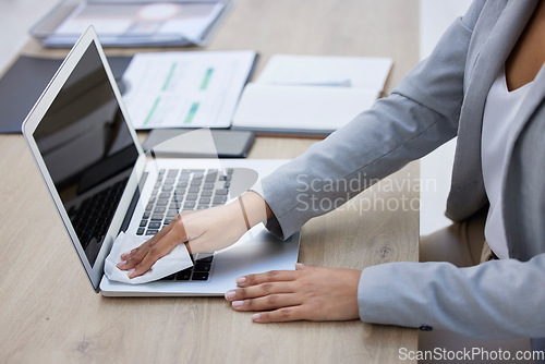 Image of Hands, laptop or cleaning cloth for hygiene, wellness or bacteria protection in modern corporate office. Business woman, technology or wiping dust for health maintenance, safety or virus disinfection