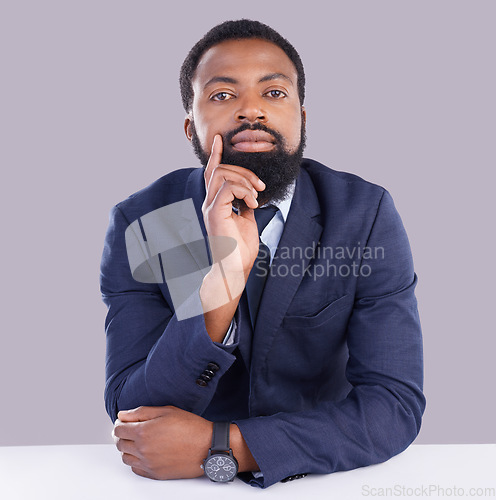 Image of Portrait, mindset and serious with a business black man in studio on a gray background thinking about the future. Face, vision and focus with a male employee sitting at a desk, contemplating an idea