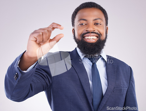 Image of Hand gesture, size and a business black man in studio on a gray background to measure company growth. Corporate, small or tiny with a happy african american male employee showing a measurement