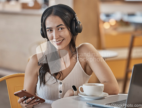 Image of Headphones, phone and woman in cafe portrait listening to music, social media and mobile app chat for remote work. Young person on smartphone, audio technology and wifi for internet in coffee shop