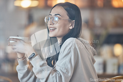 Image of Thinking, happy and a woman drinking coffee in a cafe to relax alone over the weekend behind glass. Idea, smile and caffeine with an attractive young female enjoying a beverage in a restaurant