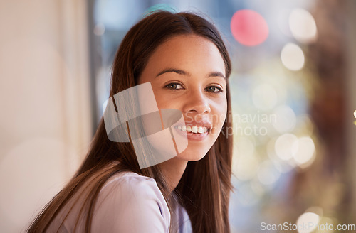 Image of Portrait, happy and a woman in a coffee shop, sitting by the window to relax alone over the weekend. Face, smile and cafe with an attractive young female customer waiting for service in a restaurant