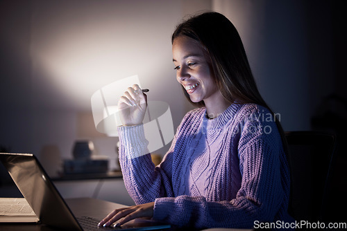 Image of Woman, happy or laptop reading in night studying, education or homework research in living room on internet elearning. Smile, student or notes planning on technology in dark house for college degree