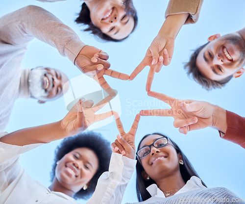 Image of Star, low angle or happy team with peace sign, diversity or community collaboration with blue sky. Portrait, smile or group of people smiling with support, solidarity or motivation together outdoors