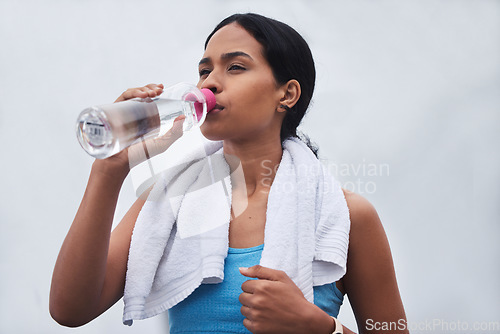 Image of Running, rest and drinking water with woman in outdoors for fitness, training and cardio endurance. Stamina, health and workout with tired female runner for jogging, exercise and performance