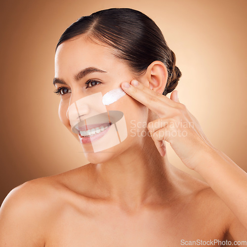 Image of Skincare, lotion and woman face cleaning of a young person smile with cream in a studio. Happy, glow and dermatology beauty treatment of a female with cosmetics, spa and cosmetology luxury facial