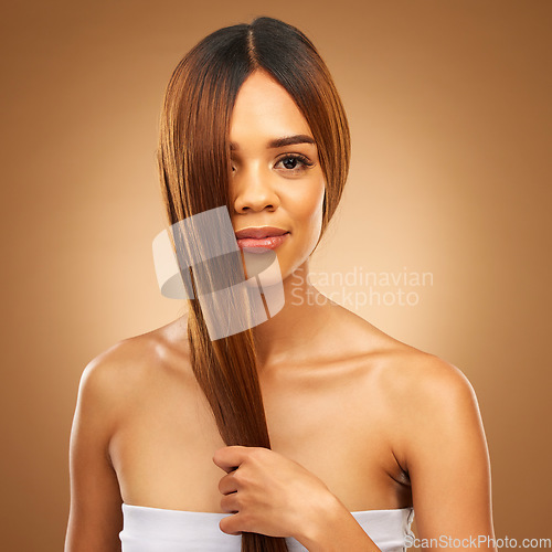 Image of Haircare, studio and portrait of woman holding strong hair in hand with texture and salon shine. Skincare model, mockup and beauty, healthy straight hairstyle with keratin product on brown background