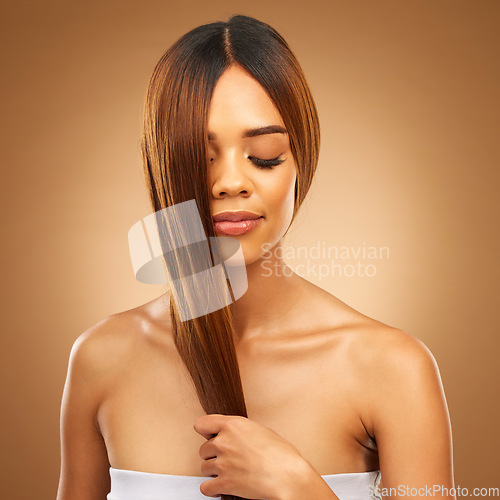 Image of Haircare, studio and woman with hair in hand, strong with bronze texture and salon shine. Wellness model, mockup and spa beauty, healthy straight hairstyle with keratin product on brown background.