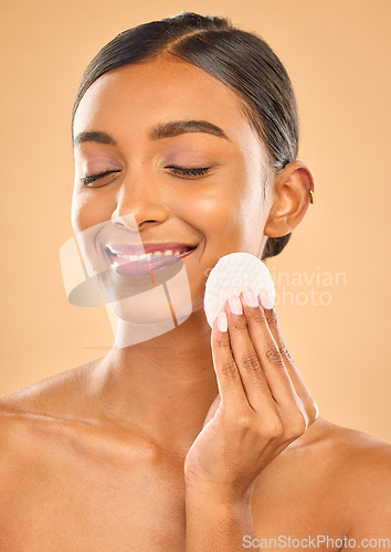 Image of Skin, beauty and face cotton of woman in studio for cosmetics, dermatology or makeup. Aesthetic female .hand with product for self care, remove makeup and natural facial results on a brown background