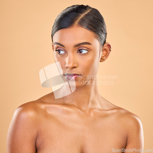 Image of Beauty, face and skin of woman serious in studio for skincare, cosmetics, dermatology or makeup. Aesthetic female for self care, natural facial and collagen shine results on a brown background