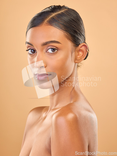 Image of Face portrait, skincare and beauty of woman in studio isolated on a brown background. Makeup, natural cosmetics and serious Indian female model with spa facial treatment for healthy or flawless skin.