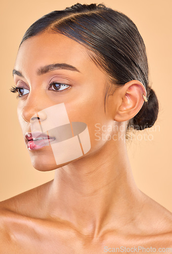 Image of Beauty, face and skin care of woman in studio for glow, cosmetics, dermatology or makeup. Aesthetic female .profile for self love, natural facial glow and skincare shine results on a brown background