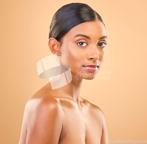 Image of Beauty, face and portrait of woman in studio for skincare, cosmetics, dermatology or makeup. Aesthetic female .serious about self care, natural skin and spa facial shine results on a brown background