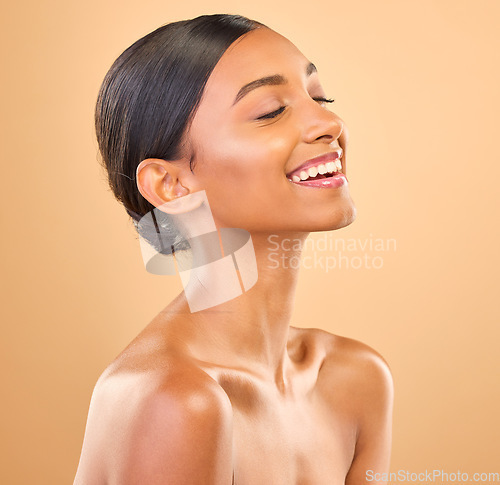Image of Beauty, face and smile of woman for skincare in studio with cosmetics, dermatology or makeup. Aesthetic female .laughing for self care, natural skin and spa facial shine results on a brown background