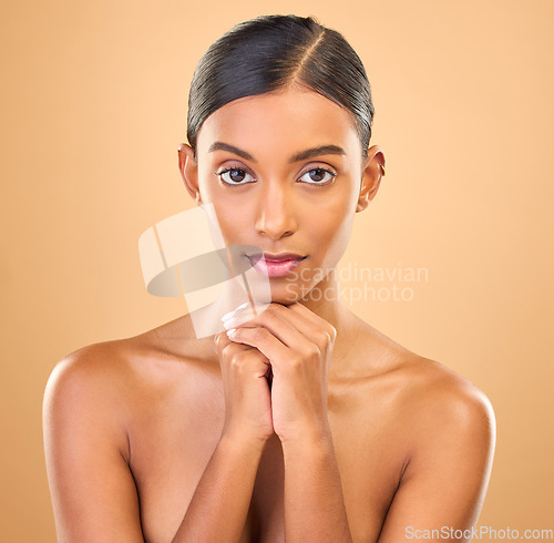 Image of Face, beauty and portrait of woman in studio for skincare, cosmetics, dermatology or makeup. Aesthetic female .serious about self care, natural skin and spa facial shine results on a brown background