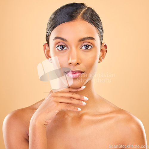 Image of Skincare, face portrait and beauty of woman in studio isolated on a brown background. Makeup, cosmetics and confident Indian female model with spa facial treatment for healthy, glow or flawless skin.