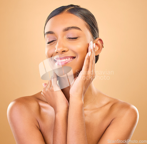 Image of Beauty, hands on face and skin of woman in studio for happy glow, cosmetics, dermatology or makeup. Aesthetic female smile for self care, natural shine and spa facial results on a brown background