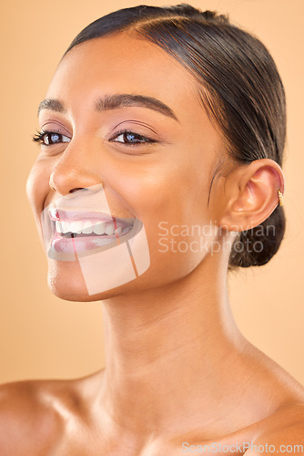 Image of Skin care, face and smile of woman in studio for glow, cosmetics, dermatology or makeup. Aesthetic female .happy about self love, natural skincare and spa facial shine results on a brown background