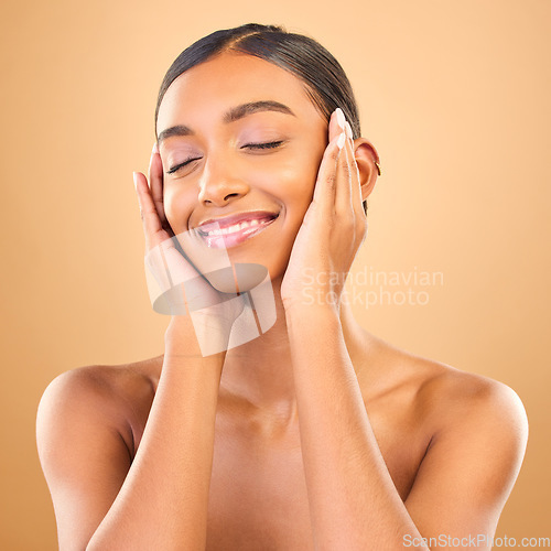 Image of Hands on face, beauty and smile of woman in studio for skincare, cosmetics, dermatology or makeup. Aesthetic female with soft skin for self care, natural facial and shine results on brown background