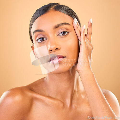 Image of Skincare, face portrait and beauty of woman in studio isolated on brown background. Makeup, serious cosmetics and confident Indian female model with spa facial treatment for healthy or flawless skin.