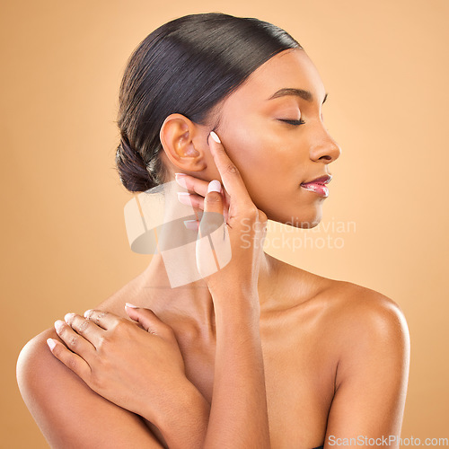 Image of Beauty, face profile and skin of woman in studio for skincare, cosmetics, dermatology or makeup. Aesthetic female model .hands for natural self care and spa facial shine results on a brown background