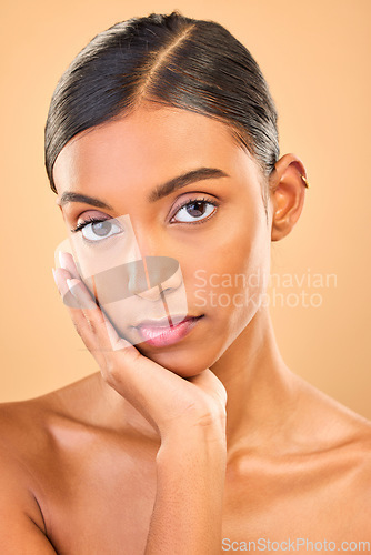 Image of Skincare, face portrait and beauty of woman in studio isolated on brown background. Makeup, serious cosmetics and confident Indian female model with spa facial treatment for healthy or flawless skin.