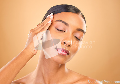 Image of Beauty, face and skin care of a woman in studio for glow cosmetics, dermatology or makeup. Aesthetic female model for self love, natural glow and spa facial shine results on brown background