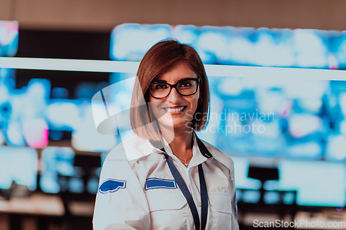 Image of Female security operator working in a data system control room offices Technical Operator Working at workstation with multiple displays, security guard working on multiple monitors