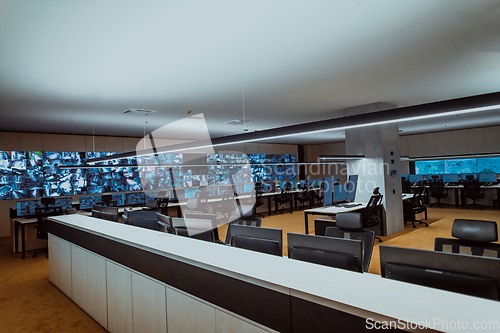 Image of Empty interior of big modern security system control room, workstation with multiple displays, monitoring room with at security data center Empty office, desk, and chairs at a main CCTV security data