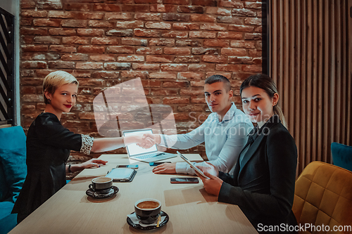 Image of Business shaking hands, finishing up meeting. Successful businesspeople handshaking after good deal