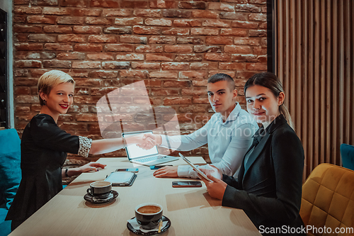 Image of Business shaking hands, finishing up meeting. Successful businesspeople handshaking after good deal