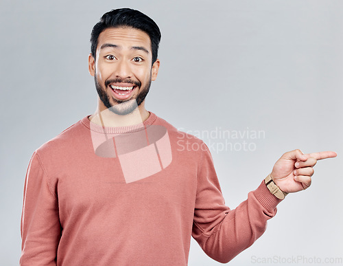 Image of Excited, gesture and portrait of Indian man pointing at mockup and product placement isolated on white background. Promotion, information and person showing deal space in studio with launch idea.