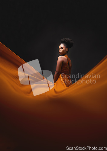 Image of Black woman, art and fashion, fabric on dark background with mockup and aesthetic movement. Flowing silk, fantasy and artistic portrait of serious African model in creative designer dress in studio.