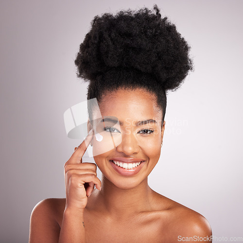 Image of Black woman, face and moisturizer cream for skincare beauty or cosmetics against a gray studio background. Portrait of happy African female with smile for moisturizing creme, lotion or facial product