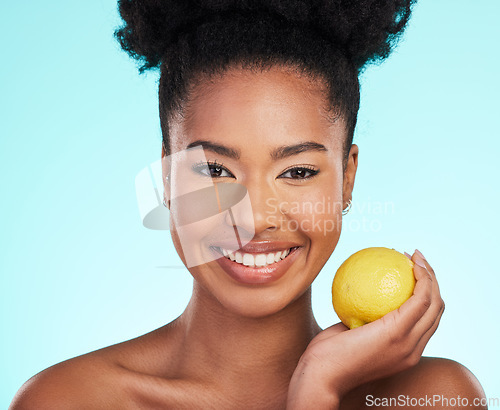 Image of Lemon, skincare beauty and woman portrait of facial, wellness and detox healthcare. Isolated, blue background and studio with a young female feeling happy from healthy food with vitamin c for glow