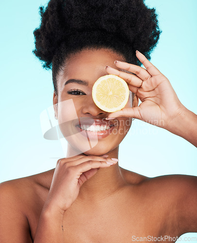 Image of Black woman, face and smile with lemon for skincare nutrition, beauty or vitamin C against studio background. Portrait of African American female smiling with fruit for natural health and wellness