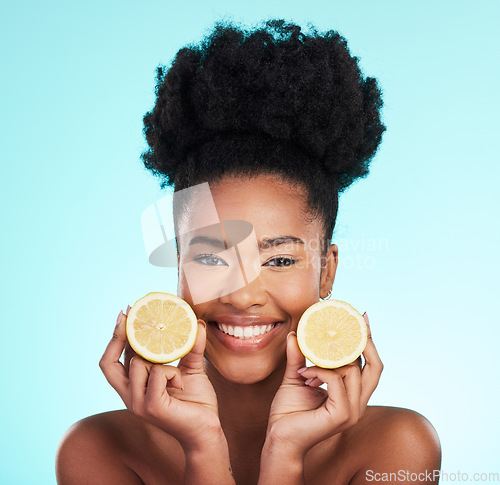 Image of Lemon, portrait and beauty of happy black woman in studio, blue background or vegan wellness. Happy model, citrus fruits and smile of facial cosmetics, vitamin c skincare or natural detox dermatology