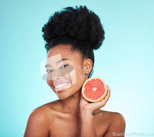 Image of Grapefruit, skincare and woman portrait of beauty, wellness and detox healthcare. Isolated, blue background and studio with a young female feeling happy from healthy food with vitamin c for glow