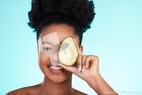 Image of Avocado, woman smile and portrait of a young model with skincare, fruit and wellness for diet. Isolated, blue background and studio with a person with beauty, cosmetics and healthy food for skin glow