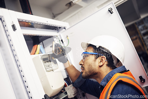 Image of Man, phone and technician in electric inspection for power or sustainable energy at work site. Male electrician, contractor or engineer with smartphone looking to inspect electricity on circuit board